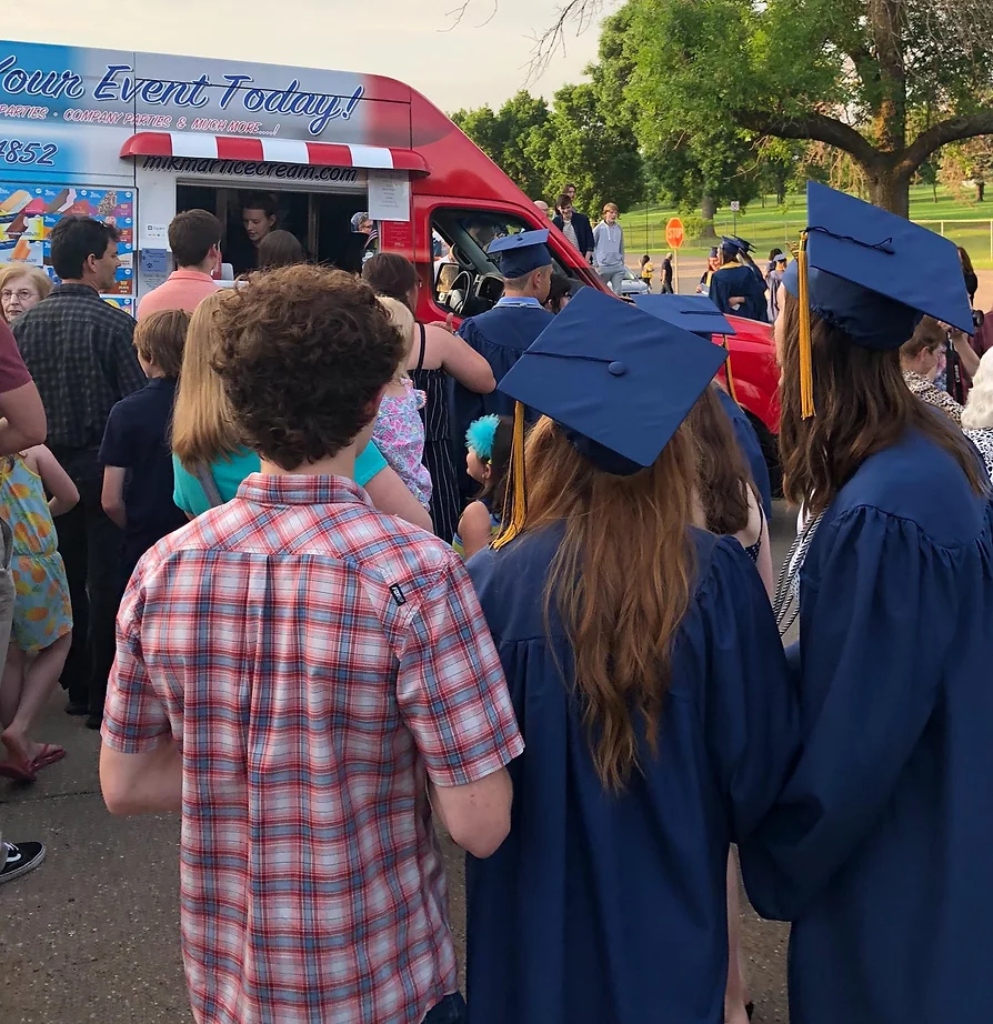 Group of people including high school graduates lined up for Mik Mart Ice Cream Truck catering